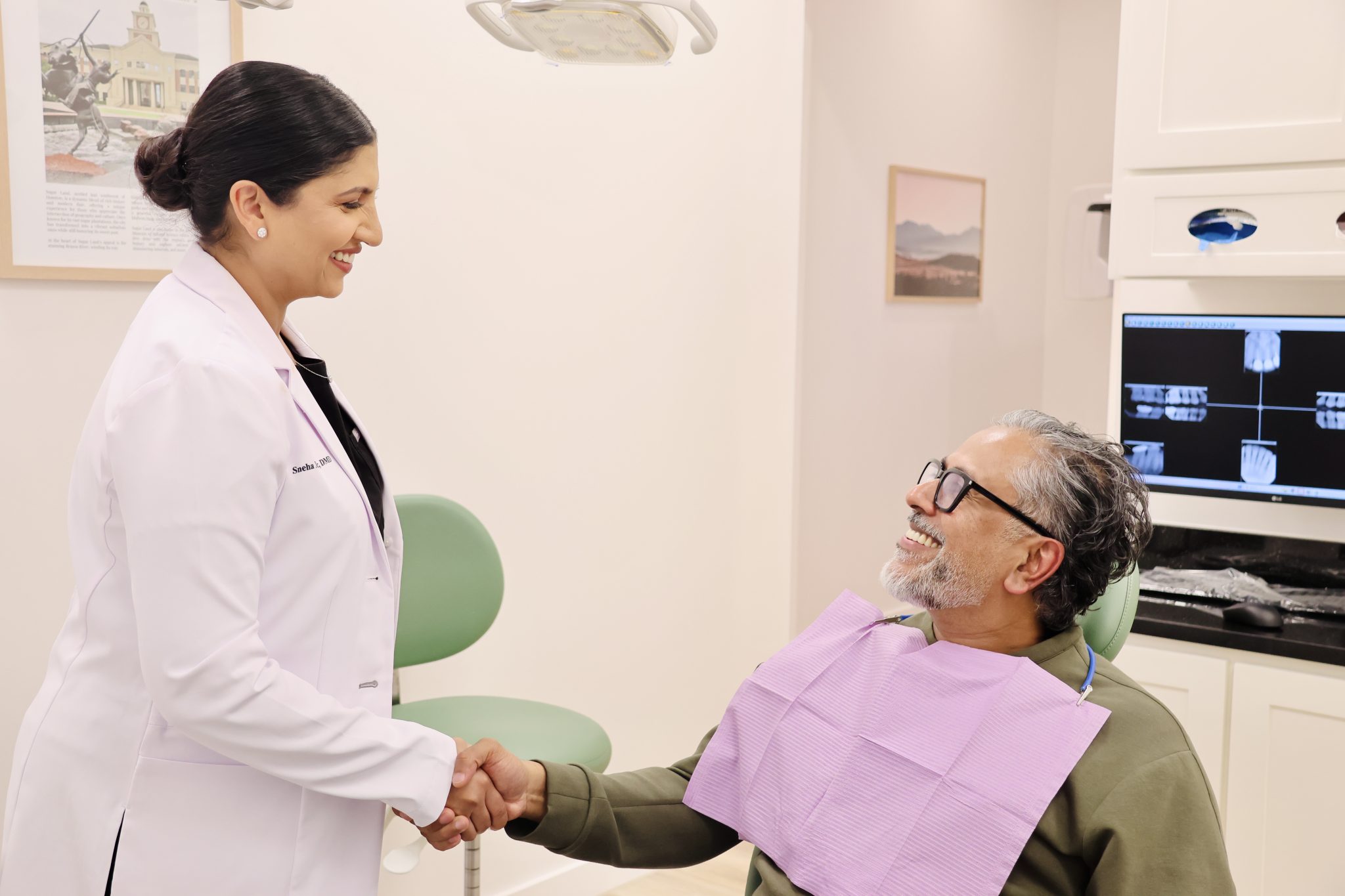 Dr. Sneha Xavier with a patient at Dept. of Smiles in Pearland